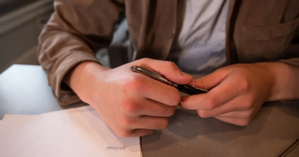 Person holding a pen over paperwork while weighing IRS payment options